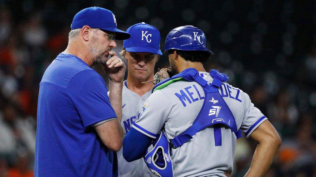 Kansas City Royals pitching coach Cal Eldred (left) visits with starting pitcher Zack Greinke and catcher MJ Melendez with the bases loaded during the fourth inning against the Houston Astros on Tuesday, July 5, 2022, in Houston.