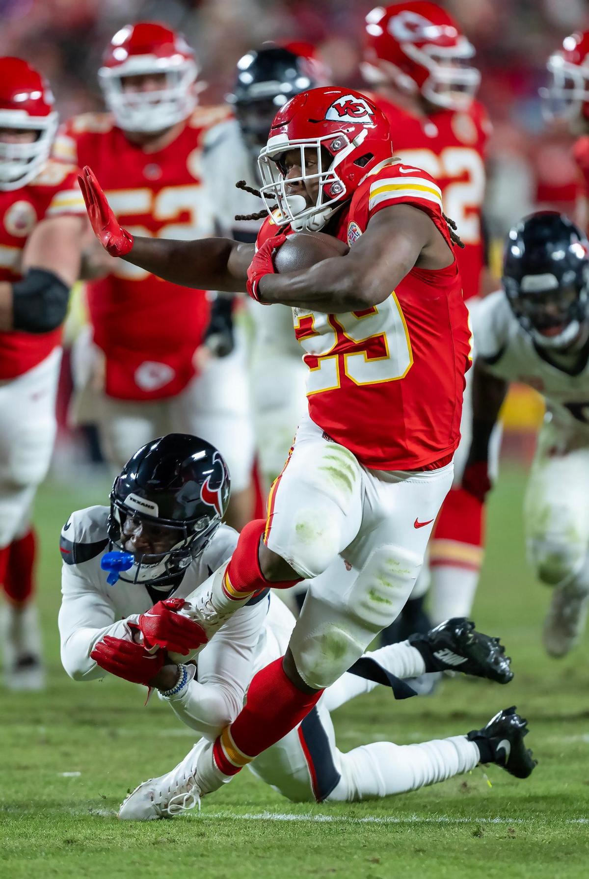 Houston Texans cornerback Kamari Lassiter (4) tries to stop Kansas City Chiefs running back Kareem Hunt (29) who runs for a first down in the second half of the AFC Divisional Round playoff game on Saturday, Jan. 18, 2025, at GEHA Field at Arrowhead Stadium. The Chiefs defeated the Texans 23-14.