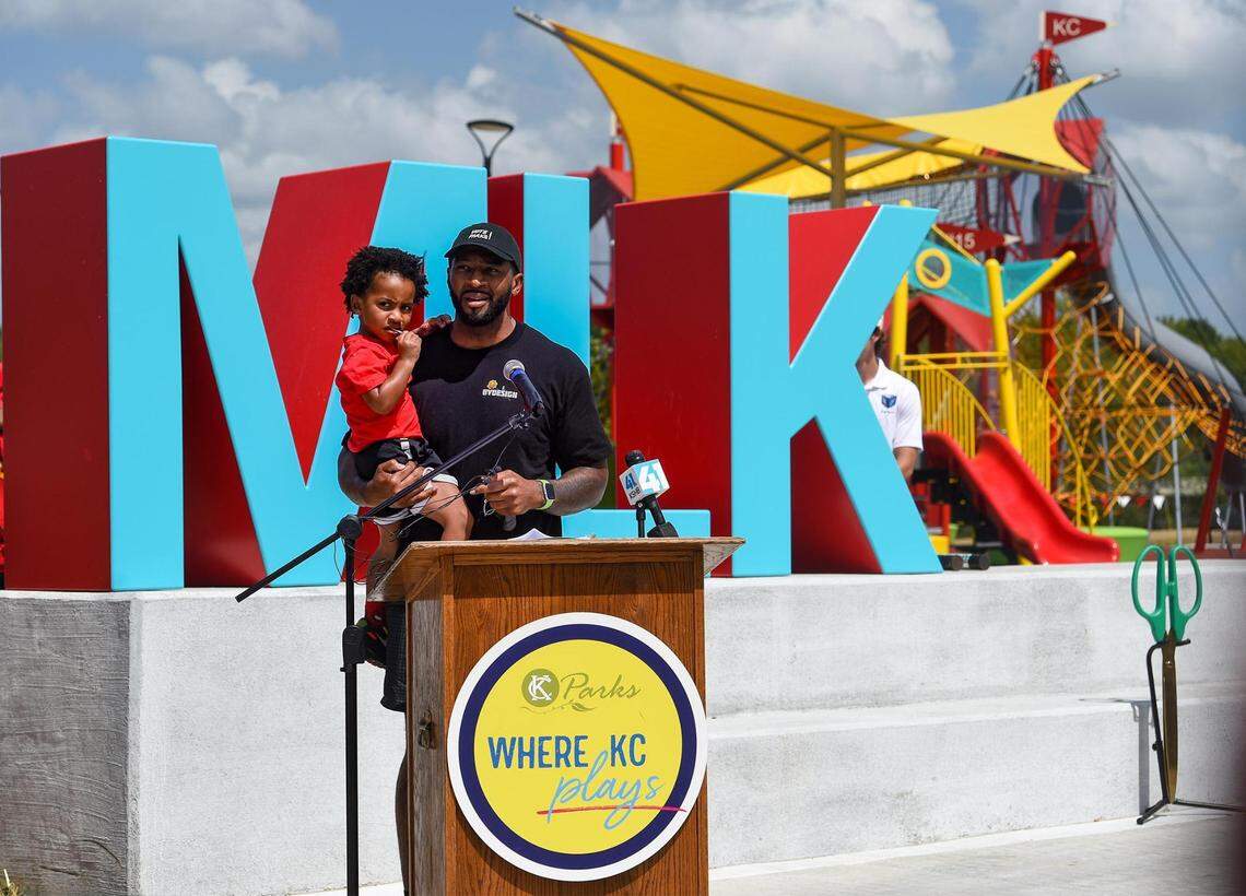 Kansas City Parks and Recreation Board Commissioner Chris Goode held his son, Levin, 2, as he gave opening remarks the 15 and the Mahomies Playground at Martin Luther King, Jr. Park on Saturday, Aug. 28, 2021, at Dr. Martin Luther King, Jr. Blvd. & Woodland Ave., in Kansas City. Chiefs quarterback’s Patrick Mahomes foundation, 15 and the Mahomies Foundation donated $1 million to help the transform the park making it accessible for children of all abilities.
