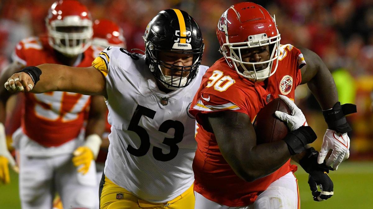 Chiefs Jarran Reed tries to get away from Pittsburgh’s Kendrick Green after scooping up a Ben Roethlisberger fumble during the second half of the Kansas City Chiefs game against the Pittsburgh Steelers at Arrowhead Stadium Sunday, Dec. 26, 2021. Kansas City beat Pittsburgh, 36-10.