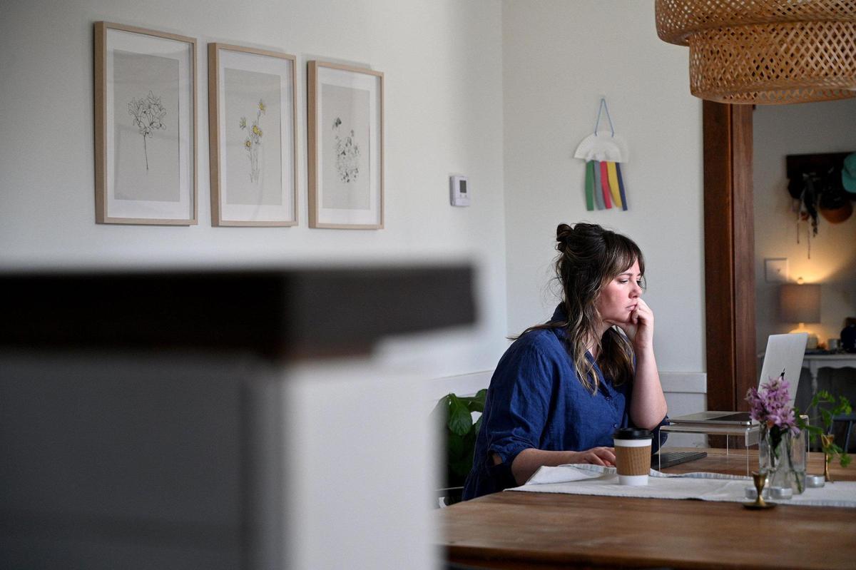 Kelly Chesley logs on to the family’s Spire account to show the gas bill online, which has risen dramatically this winter compared to past years.