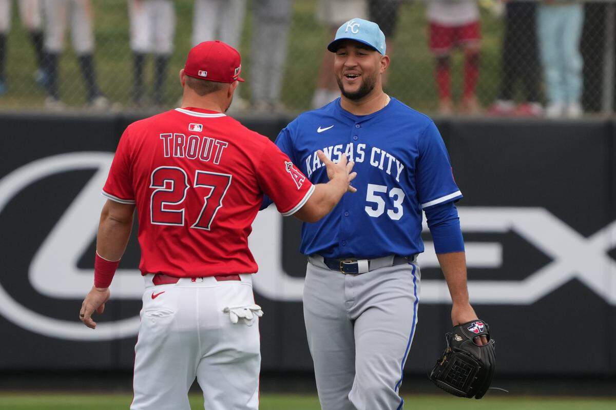 Los Angeles Angels outfielder Mike Trout (27) and Kansas City Royals pitcher Carlos Estevez (53) talk before a game at Tempe Diablo Stadium on Mar 14, 2025 in Tempe, Arizona, USA.