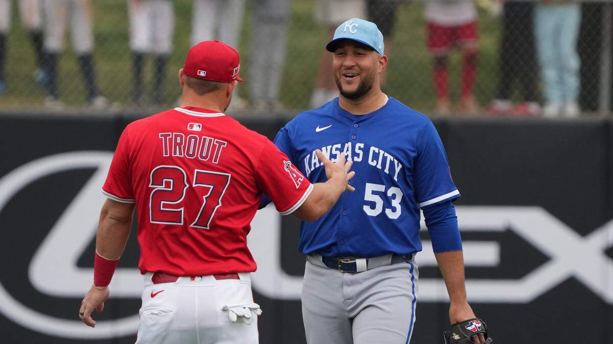 Los Angeles Angels outfielder Mike Trout (27) and Kansas City Royals pitcher Carlos Estevez (53) talk before a game at Tempe Diablo Stadium on Mar 14, 2025 in Tempe, Arizona, USA.