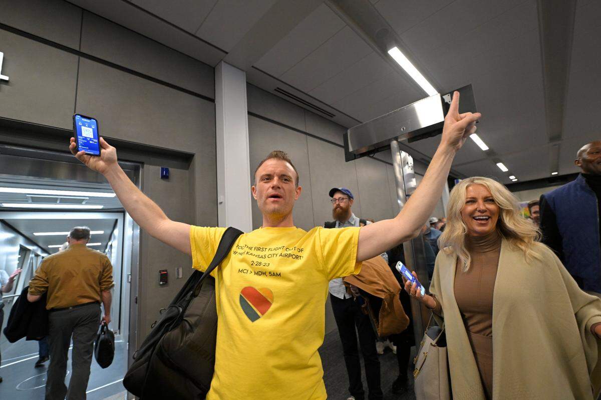 Traveler Matt Miller of Oskaloosa, Kansas, celebrated as he began boarding the first flight to depart from the new $1.5 billion single terminal at Kansas City International Airport opened to travelers Tuesday, Feb. 28, 2023. Southwest Airlines had the first flight out at 5 a.m. of the new airport to Chicago.