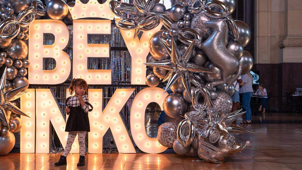Maria Sanchez stands for a photo in front of a Beyoncé sign on Friday.
