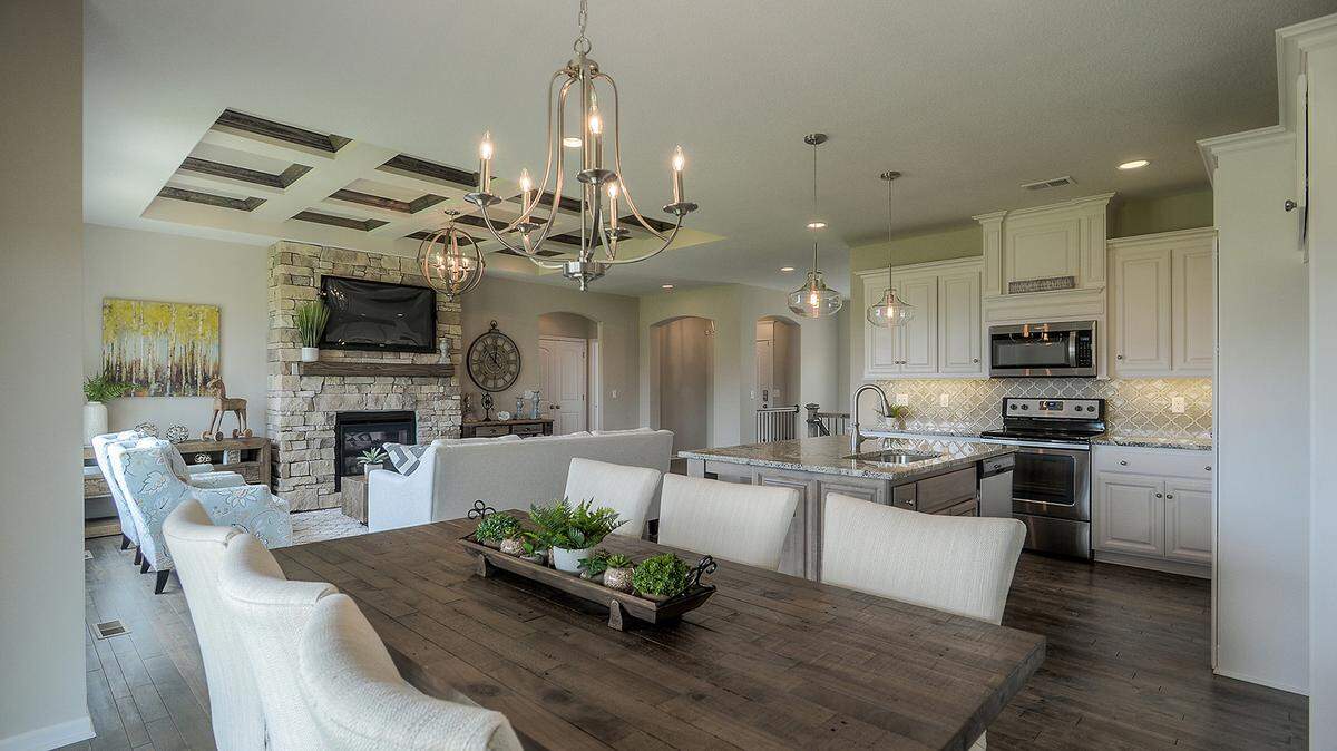 Located at 21119 W. 190th Ter., this model home—The Georgetown, by Gianni Homes—features an awe-inspiring open floor plan connecting the kitchen, dining and living rooms with beautiful hardwood floors, recessed lighting, granite countertops, and a stone fireplace.
