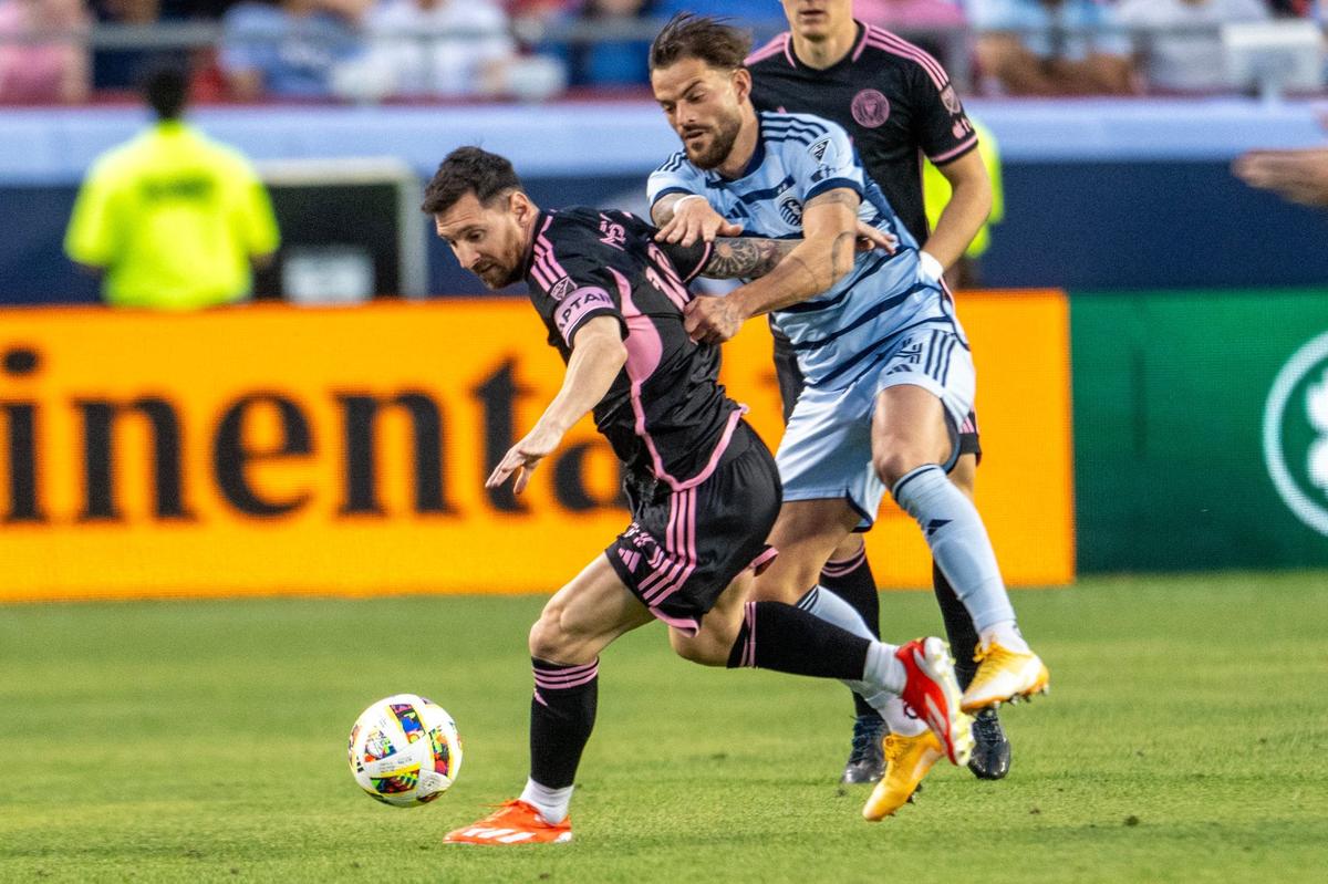 Inter Miami forward Lionel Messi (10) shields the ball from Sporting Kansas City defender Robert Voloder (4) in the first half of an MLS game against Sporting Kansas City at GEHA Field at Arrowhead Stadium on Saturday, April 13, 2024, in Kansas City.