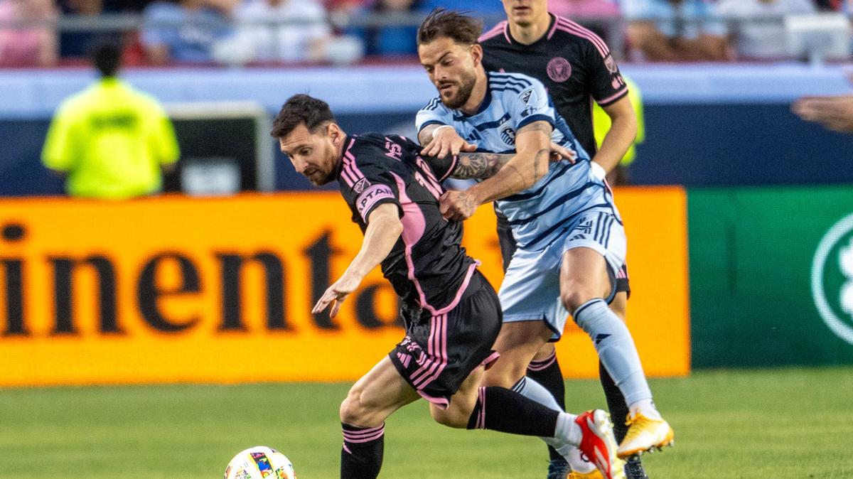 Inter Miami forward Lionel Messi (10) shields the ball from Sporting Kansas City defender Tim Leibold in the first half of an MLS game at GEHA Field at Arrowhead Stadium on Saturday, April 13, 2024, in Kansas City.