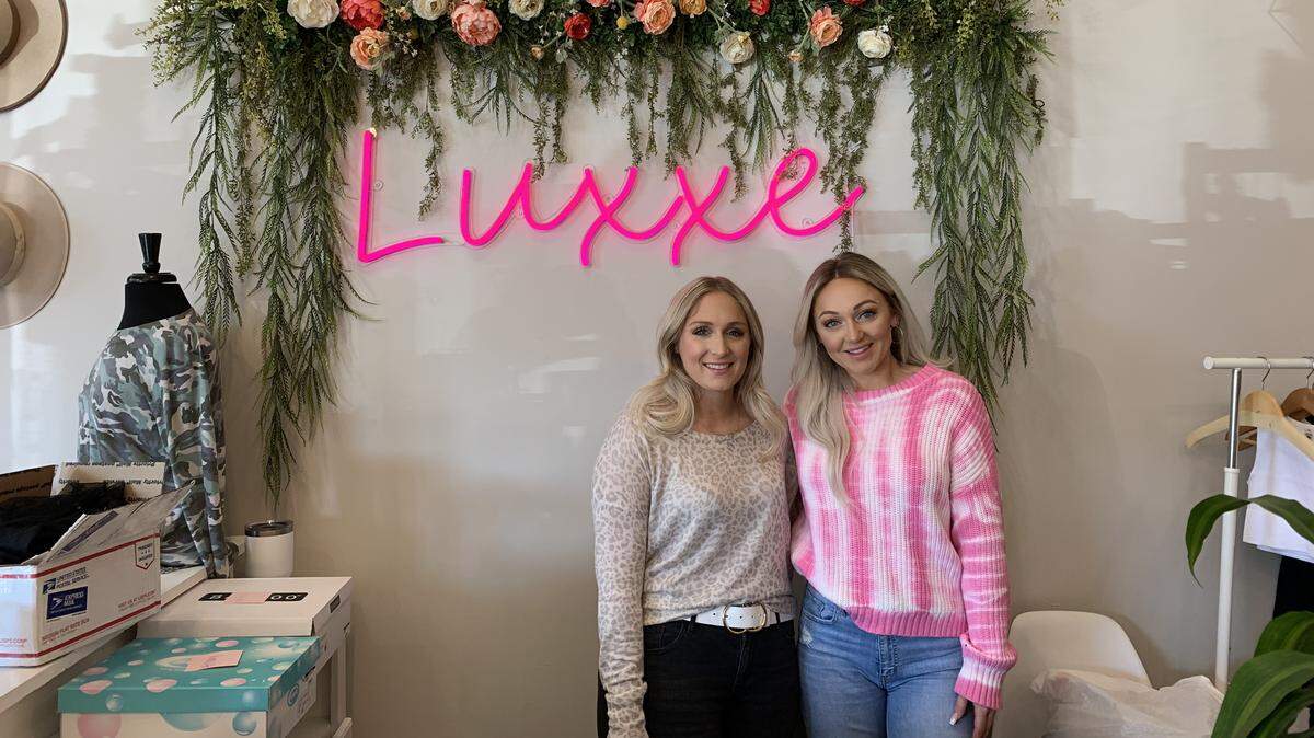Sisters Lucy Harrenstien, left, and her sister, Kassidy Harrenstien are co-owners of Luxxe Apparel. They appreciate the community spirit of Lee’s Summit.