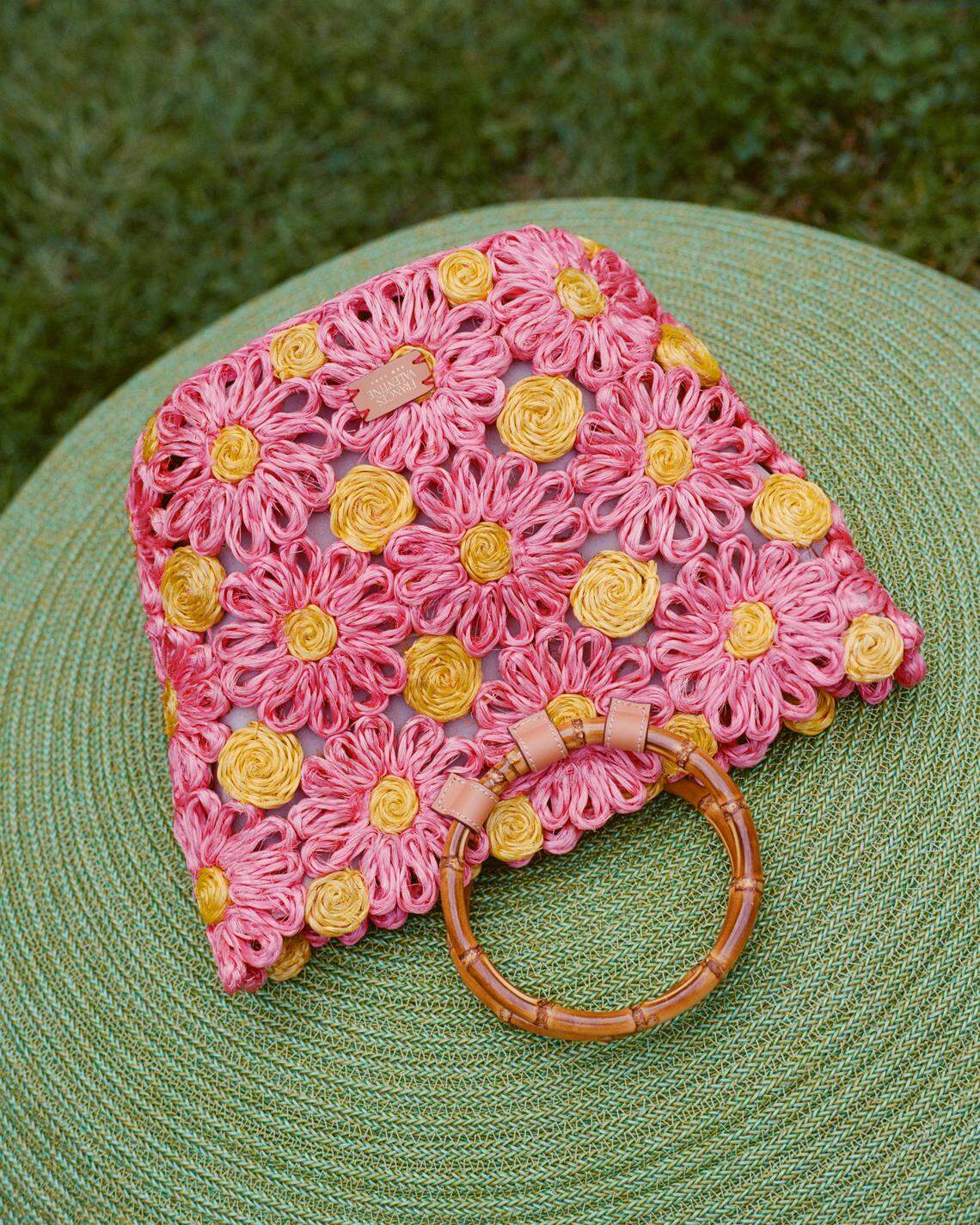 The Flora Tote by Frances Valentine has a woven raffia body, bold design and a stylish bamboo handle.