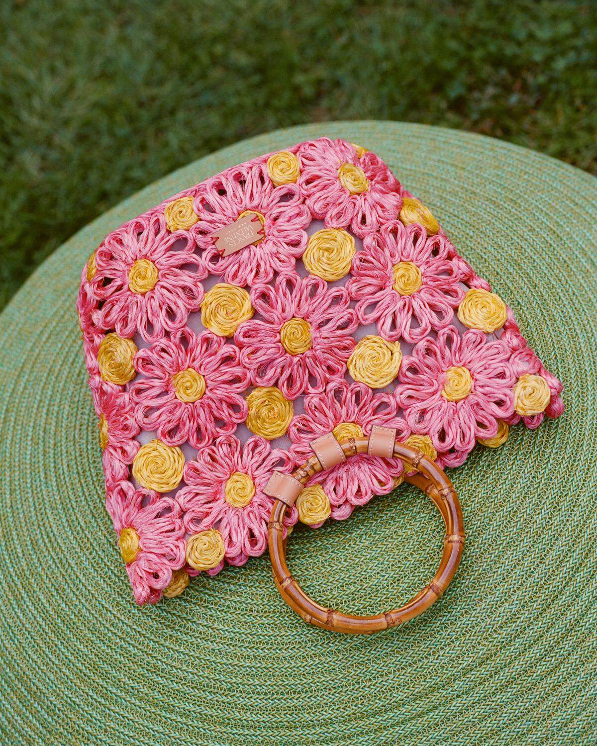The Flora Tote by Frances Valentine has a woven raffia body, bold design and a stylish bamboo handle.