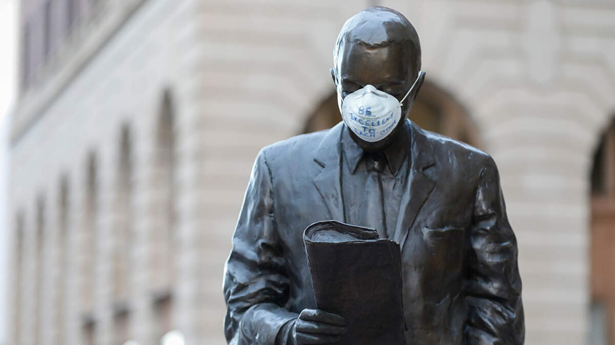A mask with the words “Be excellent to each other” was placed over the face of a statue in downtown Wichita on Friday.