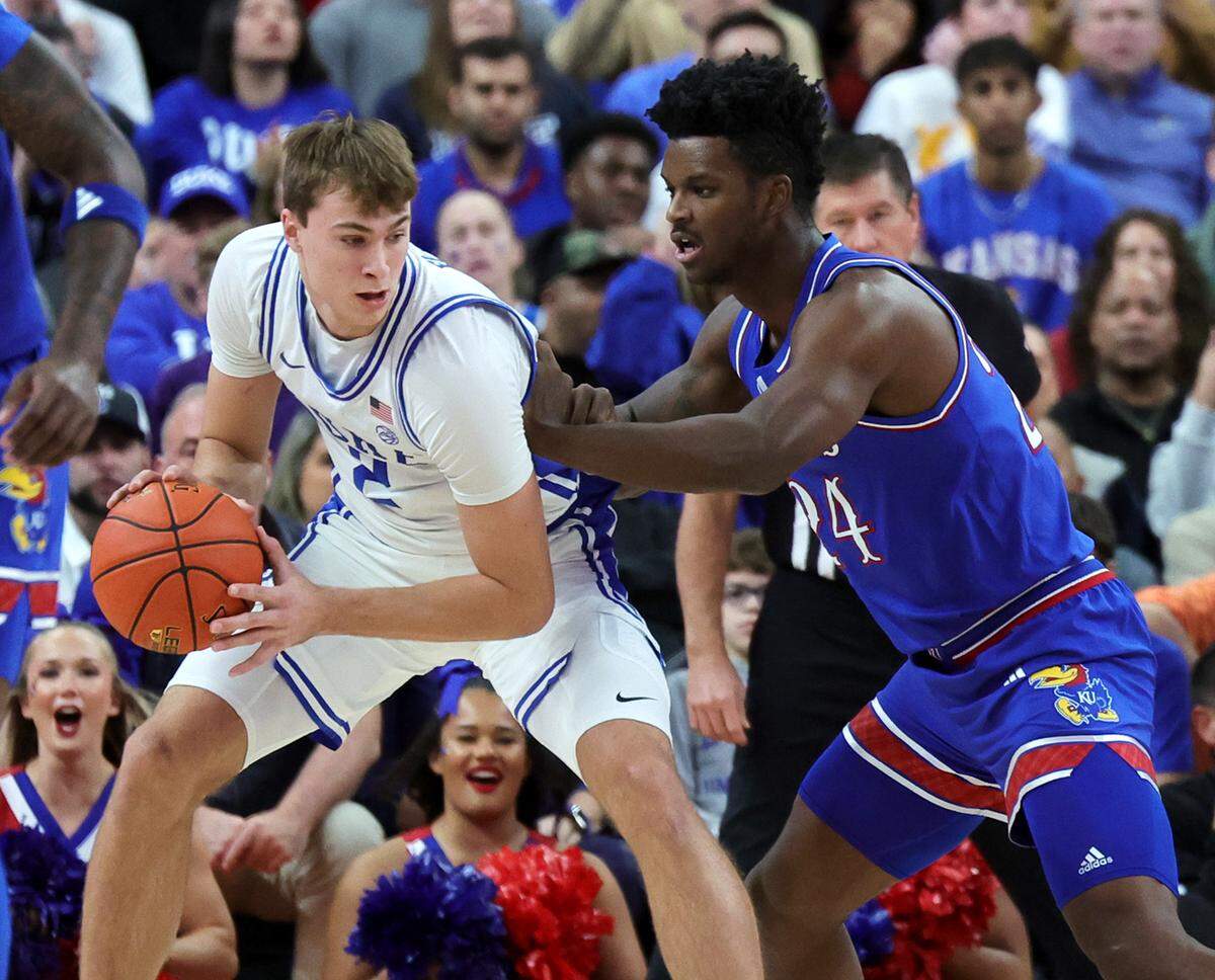 Cooper Flagg #2 of the Duke Blue Devils is guarded by KJ Adams #24 of the Kansas Jayhawks in the first half of a game during the Vegas Showdown at T-Mobile Arena on November 26, 2024 in Las Vegas.