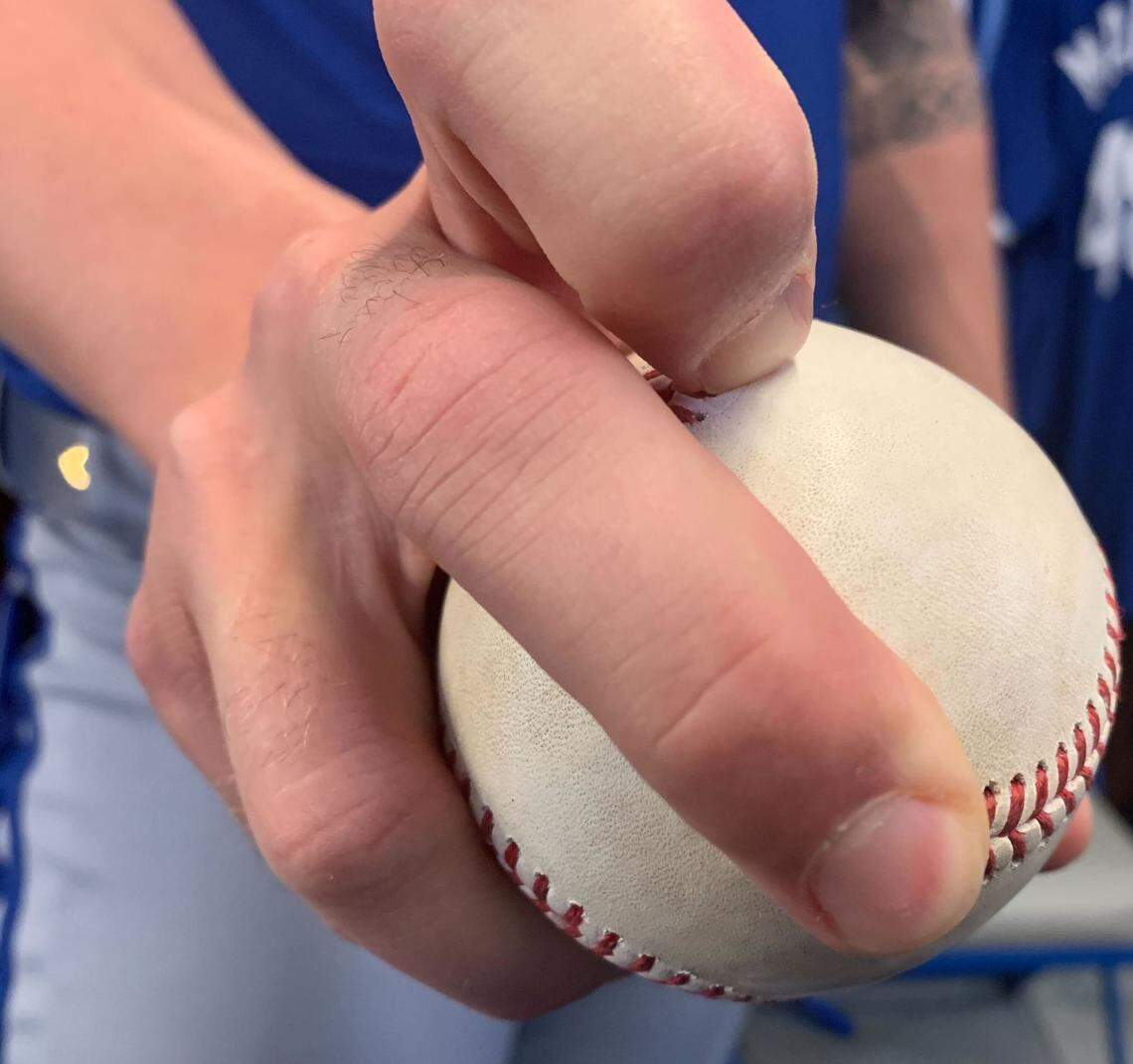 Royals pitcher Alec Marsh shows his sweeper grip in the Royals’ clubhouse in Surprise, Ariz., during 2024 spring training.
