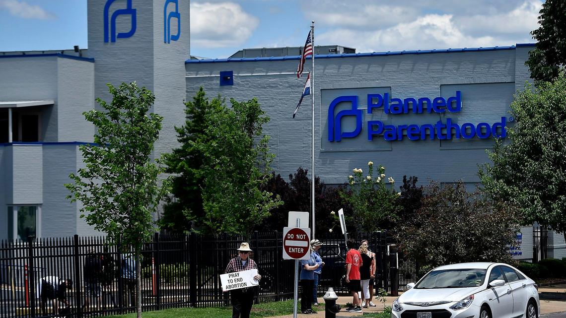 At the Planned Parenthood clinic in St. Louis, anti-abortion protesters stand in front of the clinic last Thursday. At a court hearing Wednesday, Planned Parenthood asked for a preliminary injunction to keep the state from denying its license renewal.