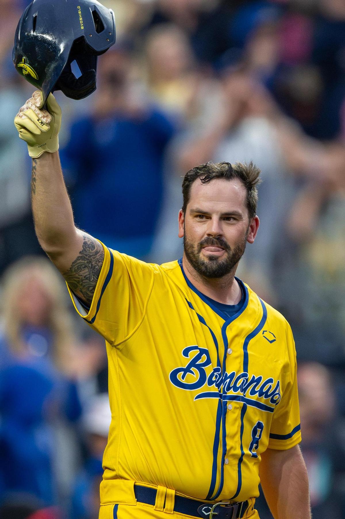 Former Kansas City Royals third baseman Mike Moustakas lifts his cap to fans before batting in the sixth inning during a Banana Ball game at Kauffman Stadium on Friday.