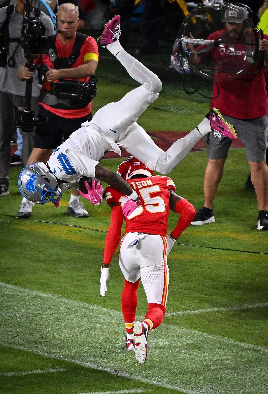 Detroit Lions wide receiver Jameson Williams (1) leaps over Kansas City Chiefs cornerback Jaylen Watson (35) during the opening drive but the Lions on Sunday, Oct. 12, 2025, at GEHA Field at Arrowhead Stadium.