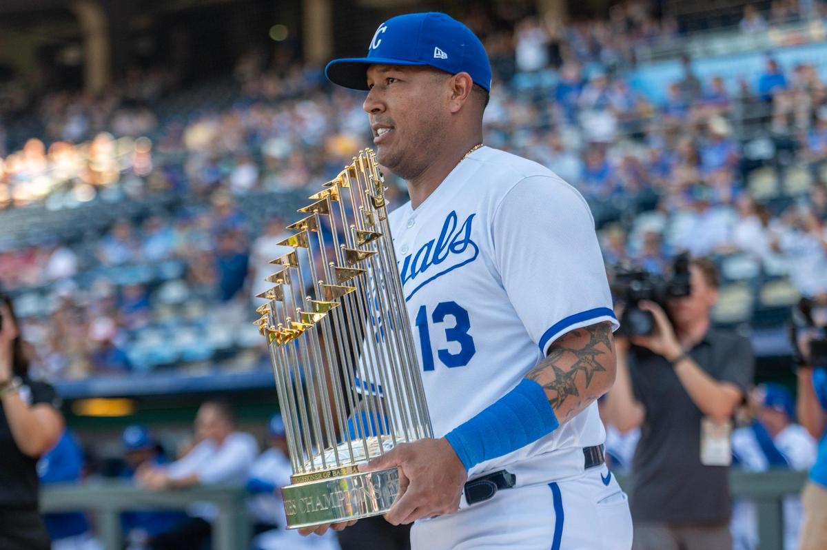 Kansas City Royals catcher Salvador Perez (13) holds the 2015 World Series trophy during a Hall of Fame induction ceremony for former manager Ned Yost at Kauffman Stadium on Saturday, Sept. 2, 2023, in Kansas City.