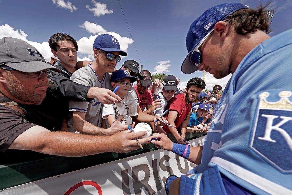 Top Kansas City Royals prospect Bobby Witt Jr. signs autographs for fans before a spring game against the Arizona Diamondbacks in Surprise, Ariz.