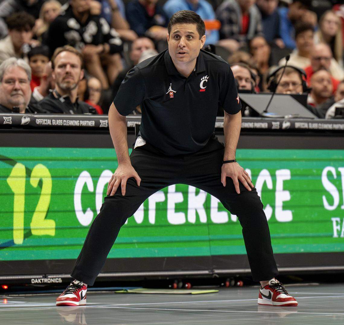 Cincinnati Bearcats men’s hoops coach Wes Miller watches from the bench during a Big 12 Men's Basketball Tournament game against the UCF Knights at T-Mobile Center on Wednesday, March 11, 2026, in Kansas City.