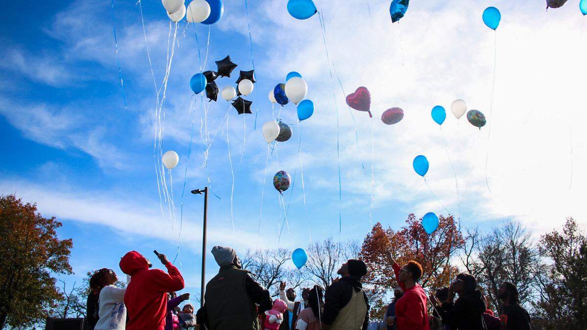 Family and friends of Kenneth R. Williams Jr, 32, gather for a balloon release in his memory outside a QuikTrip on Nov. 23, 2024. Williams was shot and killed by a Raytown police officer after allegedly making a threat about weapons and explosives in his car.