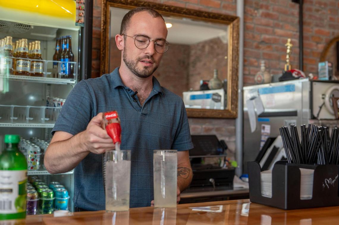 Owner of Manor Records Shaun Crowley helps customers during business hours at Manor Records on Friday, Sep. 30, 2022, in the Strawberry Hill neighborhood. Manor Records is a music shop and a bar, which is nonprofit, to help local musicians start their music career.