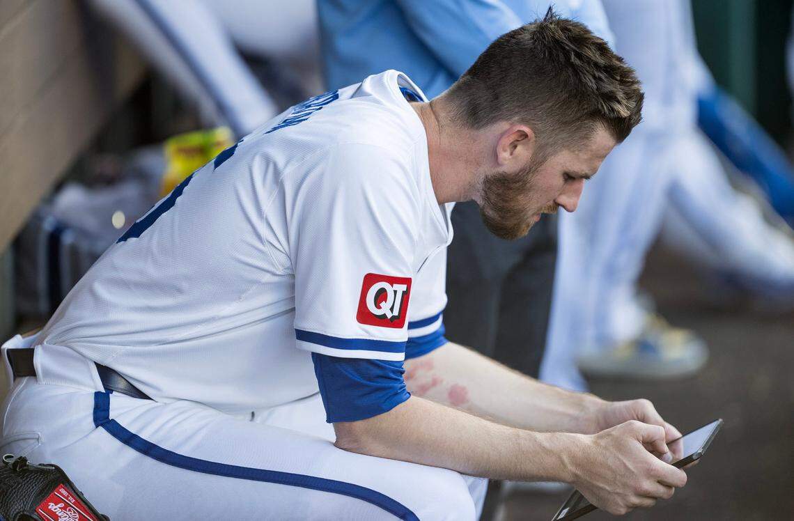 Kansas City Royals relief pitcher Chris Stratton uses a tablet to review his performance during the Royal’s home opener with the Minnesota Twins Thursday at Kauffman Stadium.