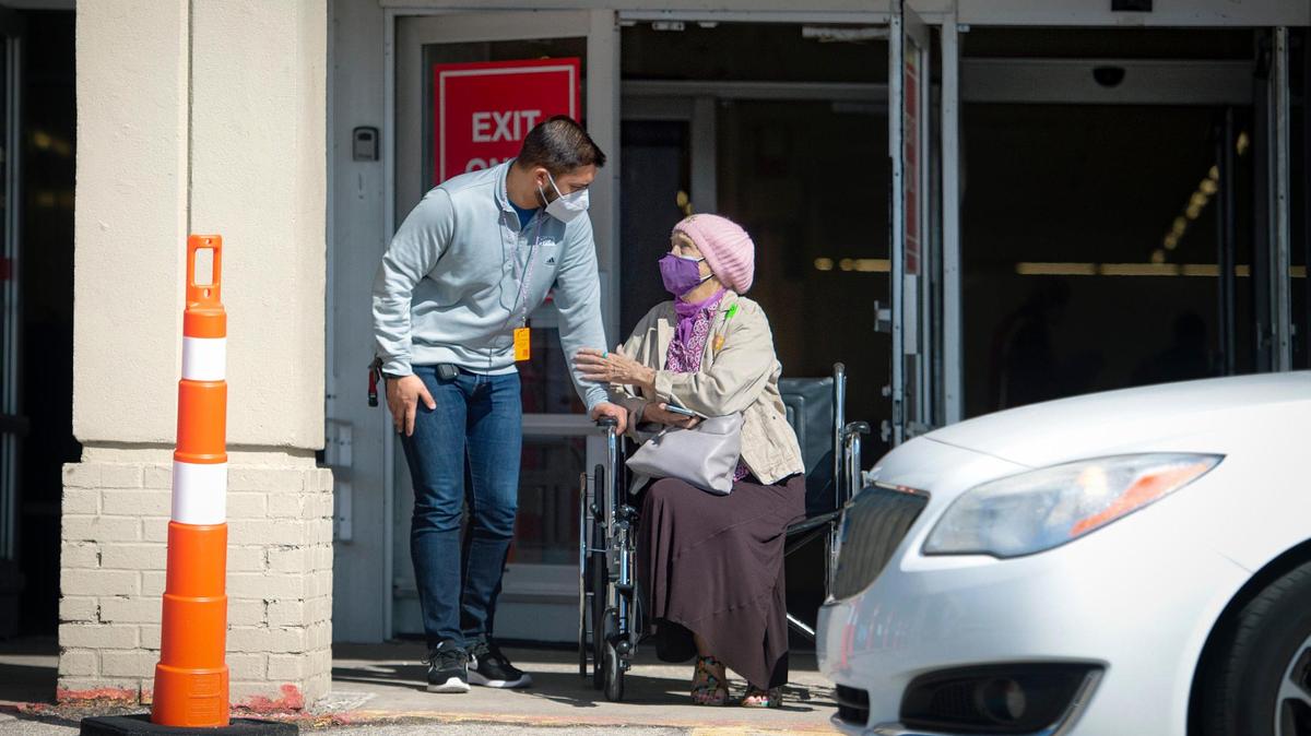 Volunteer Sharad Richardet spoke with Charlotte Tharp of Kansas City, Kansas, after she received her COVID-19 vaccination at the mass vaccination center at 7836 State Ave., in Kansas City, Kansas.