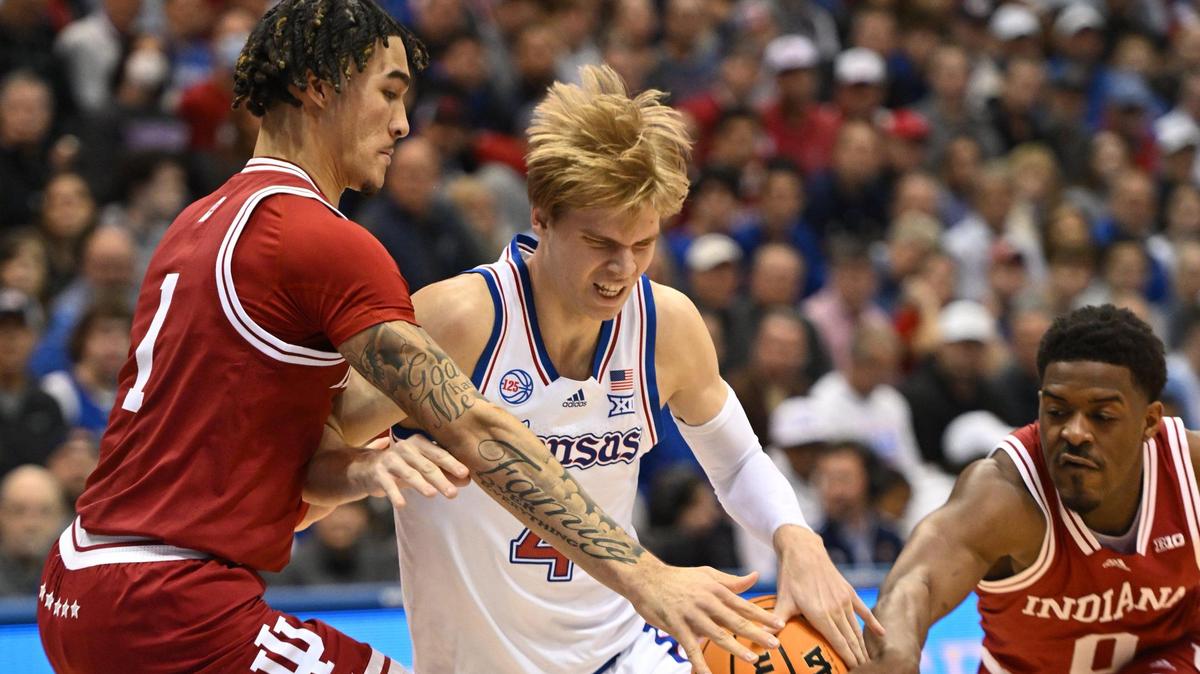 KU’S Gradey Dick drives between IU’s Jalen Hood-Schifino and Xavier Johnson during the first half of Saturday’s game at Allen Fieldhouse.