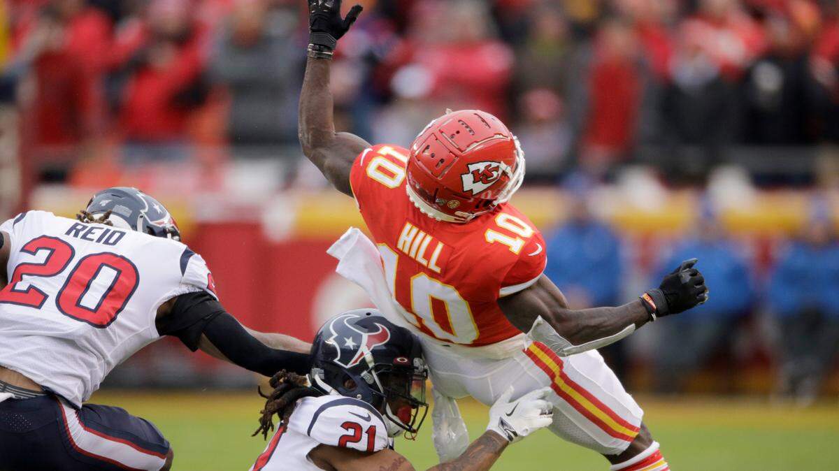 Houston Texans cornerback Bradley Roby (21) and safety Justin Reid (20) break up a pass intended for Kansas City Chiefs wide receiver Tyreek Hill (10) during the first half of an NFL divisional playoff football game, in Kansas City, Mo., Sunday, Jan. 12, 2020. (AP Photo/Charlie Riedel)