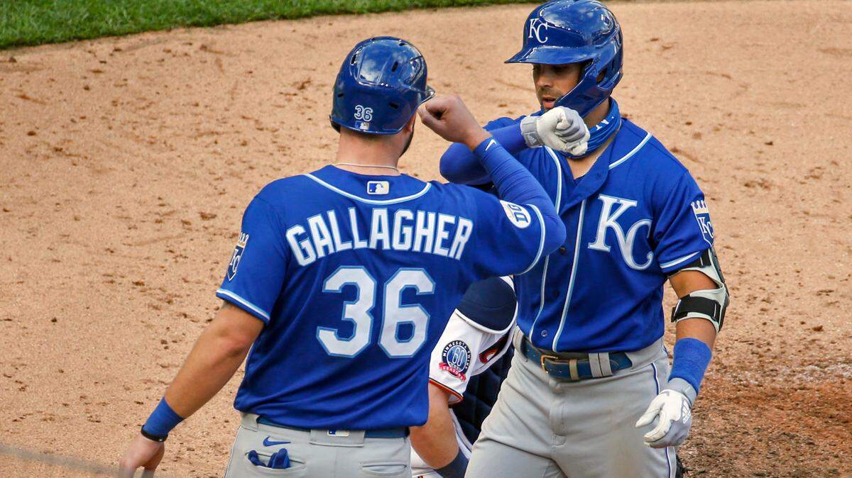 The Royals’ Whit Merrifield (right) celebrates with Cam Gallagher after Merrifield’s three-run home run against the Minnesota Twins in the fourth inning of the second game of a doubleheader on Saturday, Aug. 15, 2020, in Minneapolis. The Royals won 4-2.
