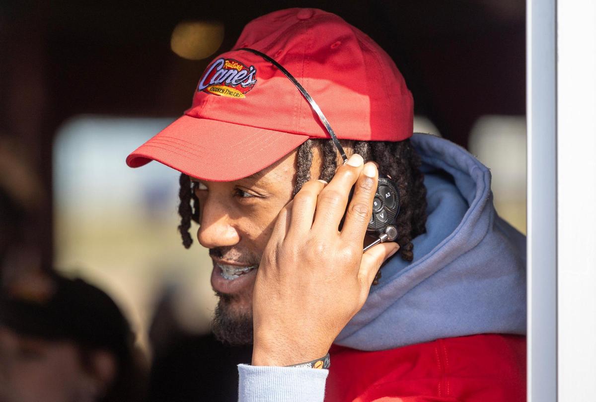 Kansas City Chiefs cornerback L’Jarius Sneed works the drive through at a Raising Cane’s restaurant in Blue Springs on Tuesday. Sneed was joined by teammate Mecole Hardman Jr. at the event.