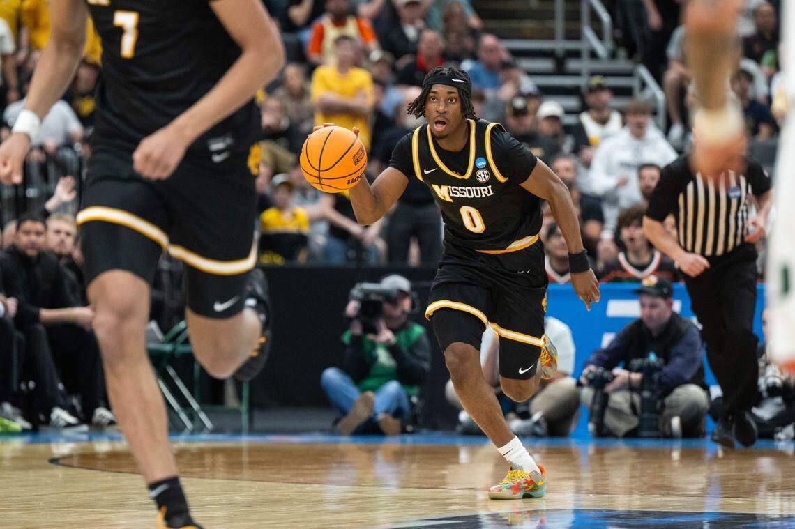 Missouri Tigers guard Anthony Robinson II (0) pushes the ball up the court on a fast break in the second half of the Tigers first-round NCAA Tournament matchup vs. the Miami Hurricanes at Enterprise Center in St. Louis on Friday, March 20, 2026.