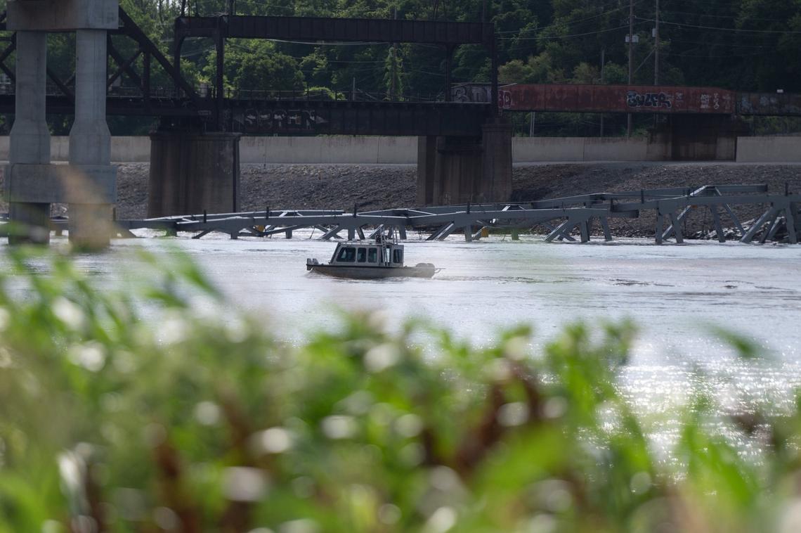 The debris of the final arch of the Buck O’Neil Bridge rests in the Missouri River near downtown Kansas City after Tuesday after it was brought down with explosive charges.
