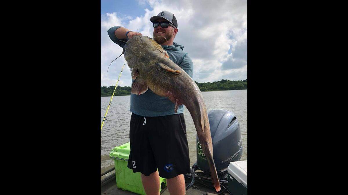 Guide Jeff Faulkenberry’s client shows off a nearly record-breaking flathead catfish caught at Truman Lake. The big cat came up just a few ounces short (on an unofficial scale) of the rod-and-reel Missouri state record.