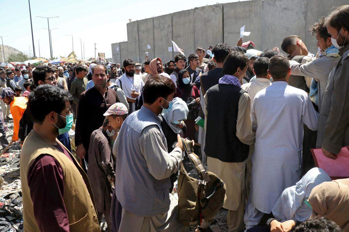 Hundreds of people gather near an evacuation checkpoint at Hamid Karzai International Airport in Kabul, Afghanistan, on Thursday, Aug. 26, 2021. Kansas City is receiving up to 550 Afghan evacuees.
