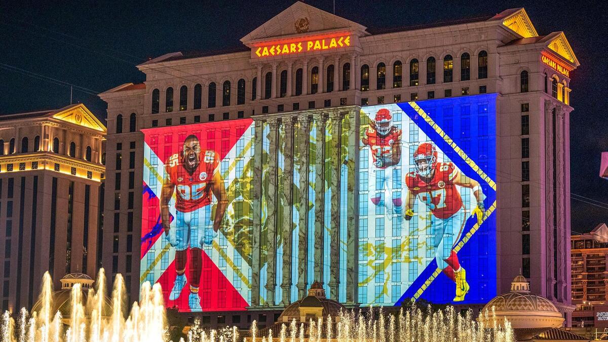 Super Bowl-themed murals, inlcuding one with Kansas City Chiefs defensive tackle Chris Jones and tight end Travis Kelce was projected on the side of Caesars Palace where fans took in the sights including the fountains of Bellagio Las Vegas on on Thursday, Feb. 8, 2024, in Las Vegas, Nevada.