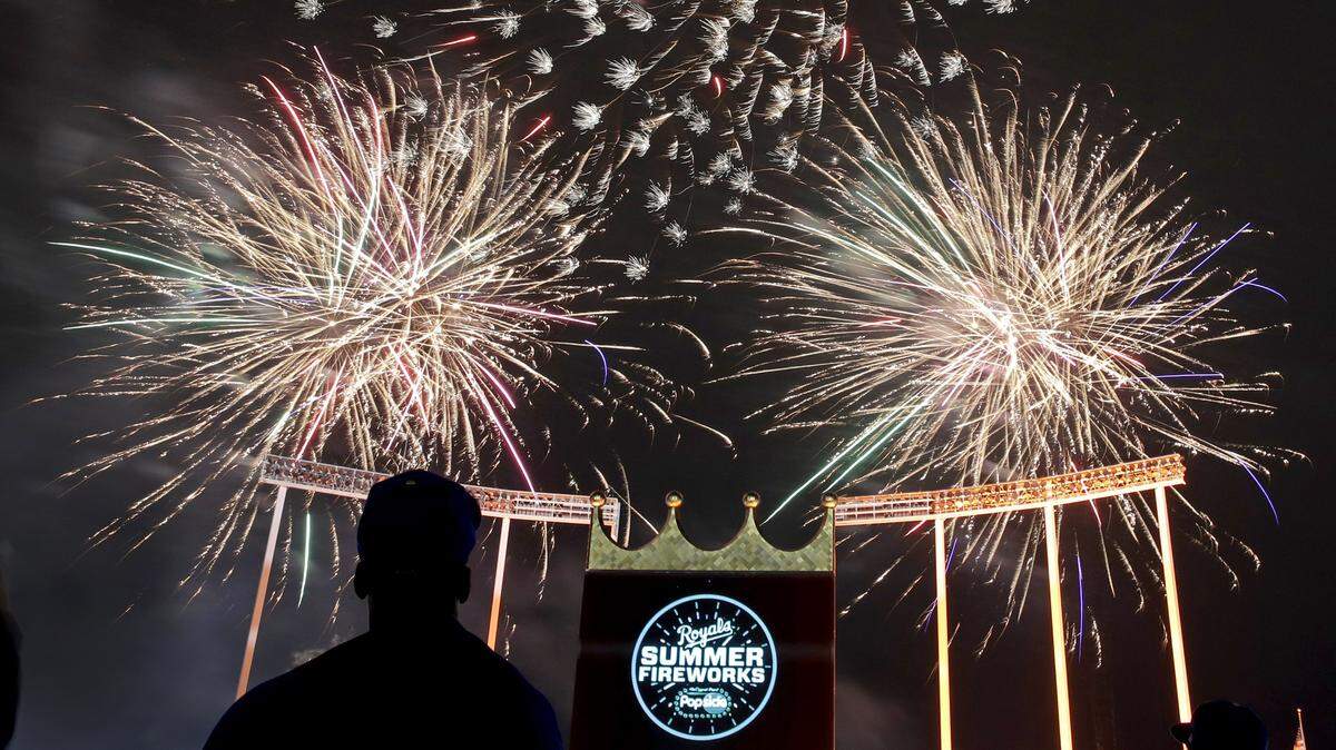 People watch fireworks after a baseball game between the Kansas City Royals and the Philadelphia Phillies on Friday, May 10, 2019, in Kansas City.