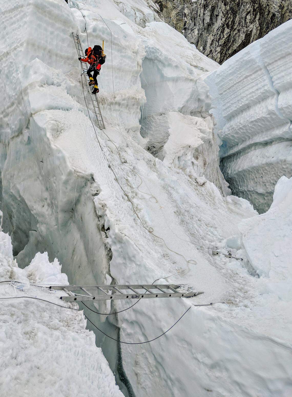 Elsa Bleeker, one of Becker’s climbing partners, ascends a ladder in the Khumbu Icefall.
