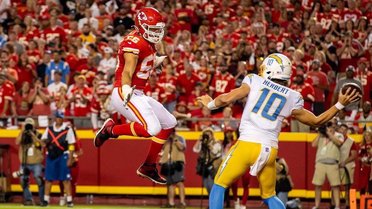 Kansas City Chiefs defensive end George Karlaftis (56) disrupts the pass attempt of Los Angeles Chargers quarterback Justin Herbert (10) during the home opener between the Kansas City Chiefs and the LA Chargers on Thursday September 15, 2022 at GEHA Field at Arrowhead Stadium in Kansas City, Missouri.