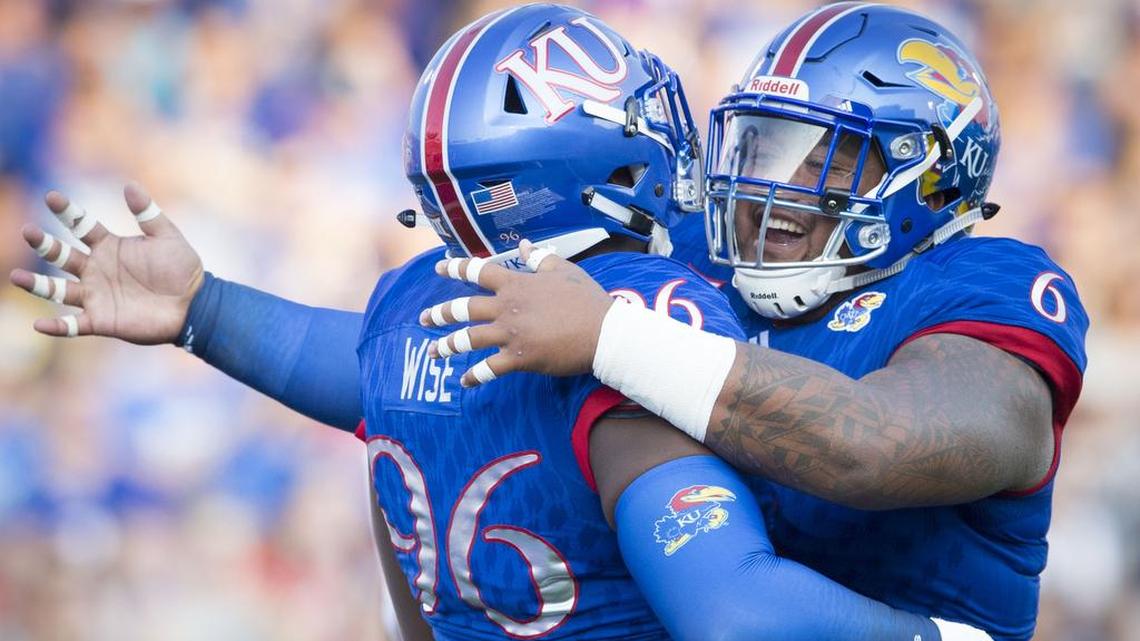 Kansas Jayhawks defensive tackle Isi Holani, right, celebrated a quarterback pressure with teammate Daniel Wise in this 2017 file photo.