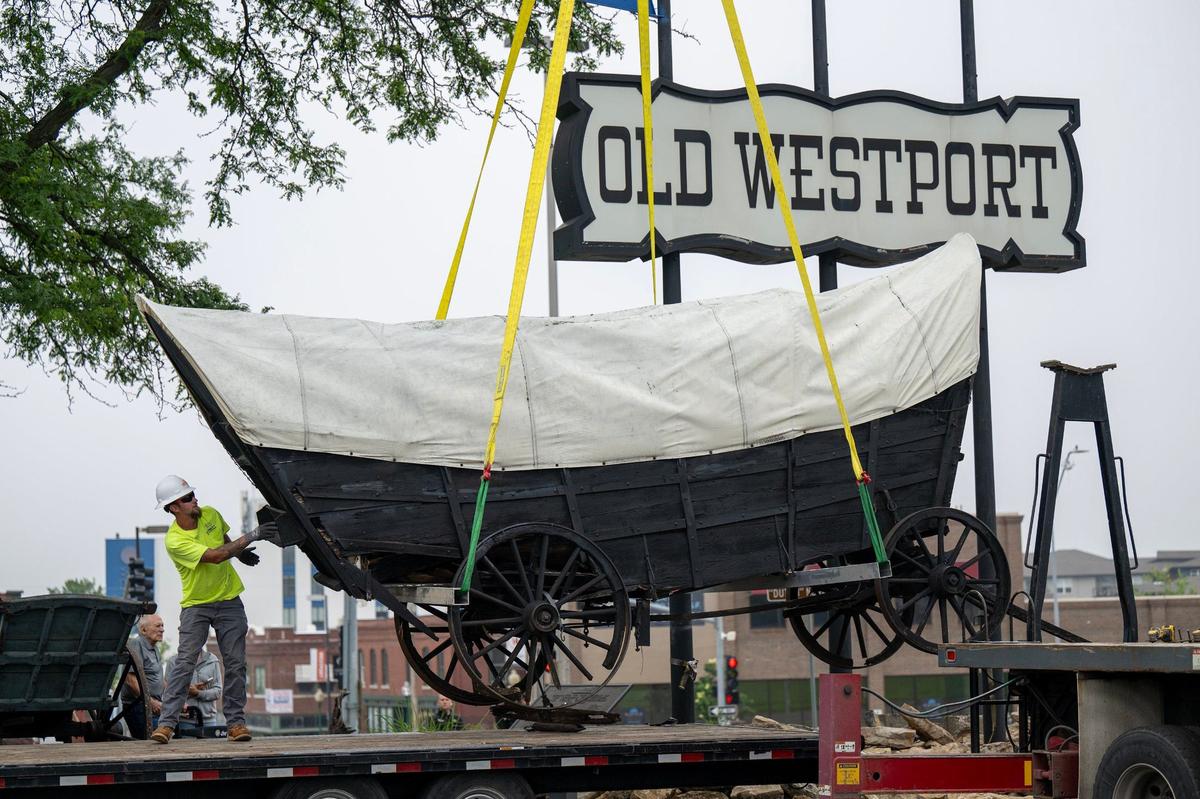 Workmen in June removed a Conestoga-type covered wagon that had stood since 1963 at the Old Westport Shopping Center.