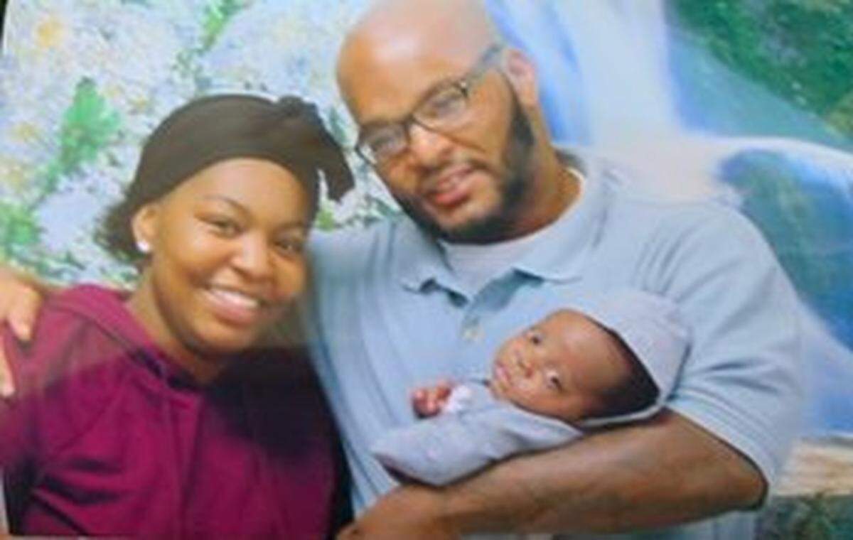 Kevin Johnson is pictured with his daughter Khorry and her newborn son.