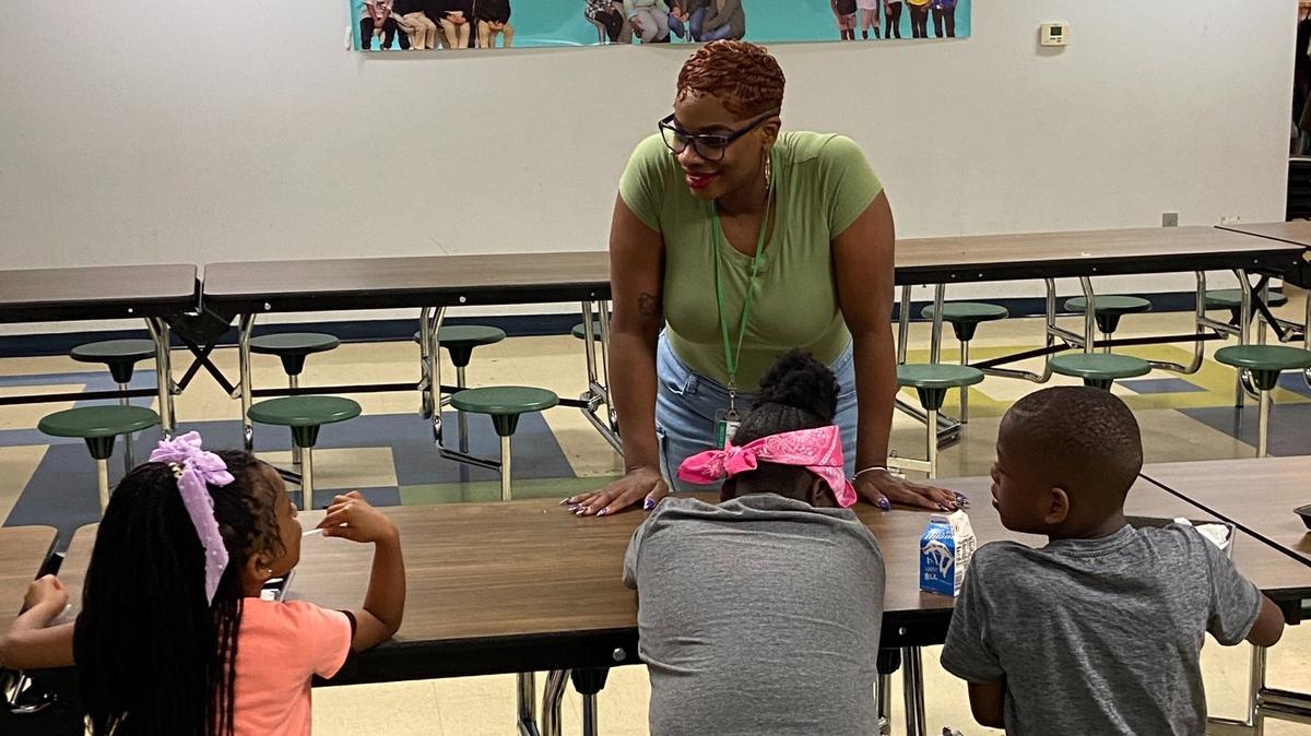 Executive Director Tiffaney Whitt with students in the lunch room at Hope Leadership Academy.