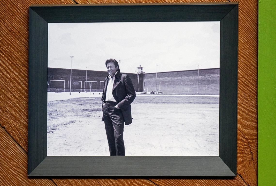 A photo at the Lansing Historical Society Museum shows Cash standing in the yard inside the Kansas State Penitentiary during his visit to perform for inmates.