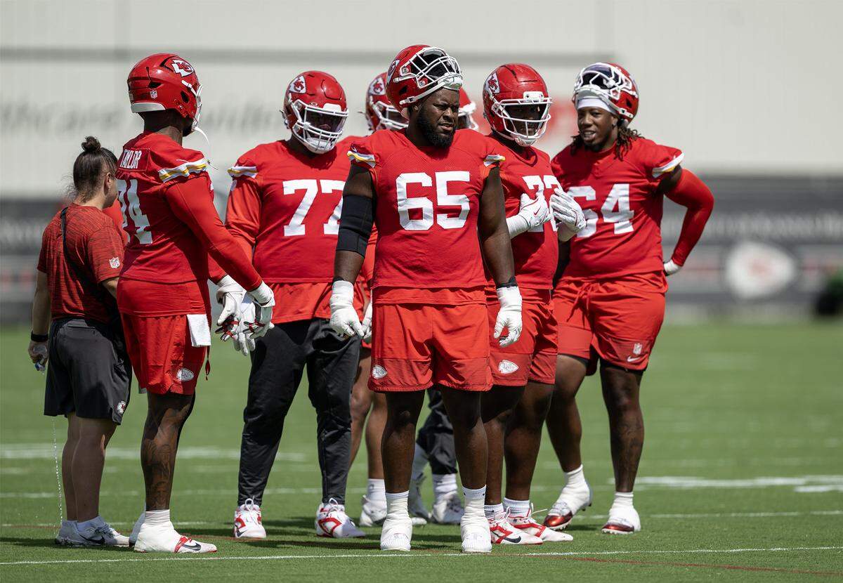 Kansas City Chiefs guard Trey Smith (65) and other during warm ups at practice at team's training facility on Wednesday, August 20, 2025. in Kansas City