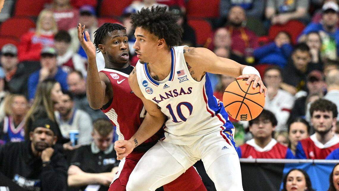 Kansas Jayhawks forward Jalen Wilson (10) dribbles against Arkansas Razorbacks guard Davonte Davis (4) during the second half at Wells Fargo Arena in Des Moines on March 18, 2023.