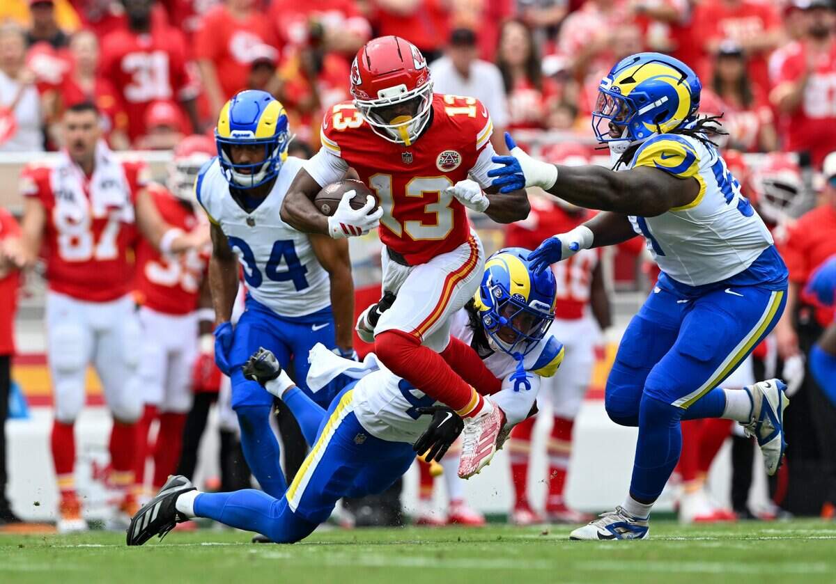 Kansas City Chiefs wide receiver Cyrus Allen (13) runs the ball and dodges the Los Angeles Rams defense in the first quarter of the preseason game at Arrowhead Stadium in Kansas City on Aug. 15, 2026.