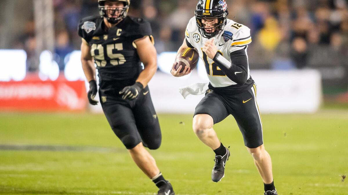 Missouri quarterback Brady Cook (12) scrambles up field during the Lockheed Martin Armed Forces Bowl game between the Army Black Knights and the Missouri Tigers on Wednesday December 22, 2021 in Fort Worth, Texas.