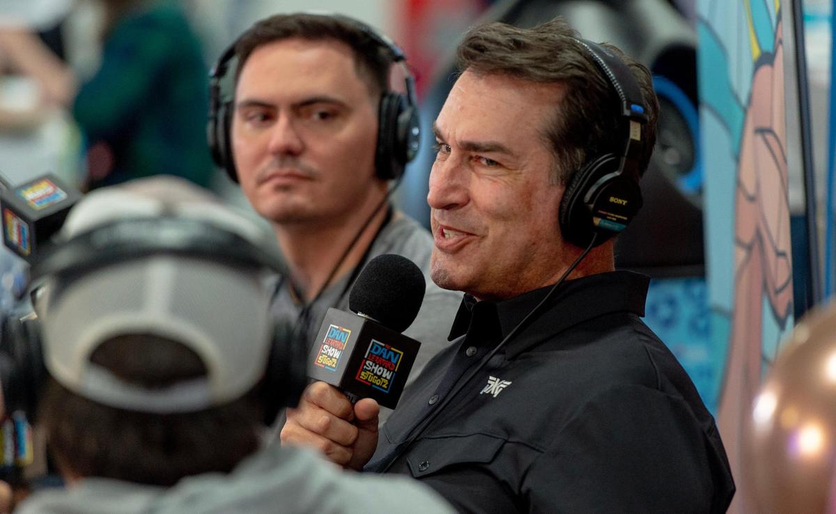 Actor and Kansas City Chiefs fan Rob Riggle talks on a podcast at Super Bowl LVII’s Media Row on Friday, Feb. 10, 2023, in Phoenix, Ariz.
